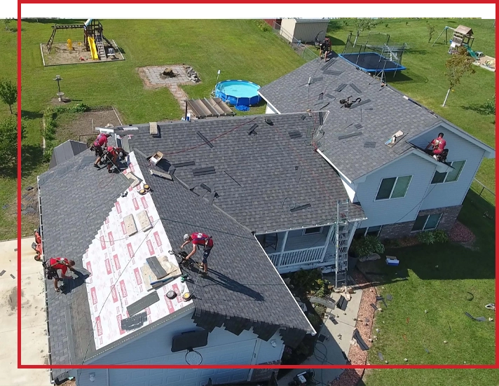 A team of roofers works on a roofing replacement project in Minnesota.