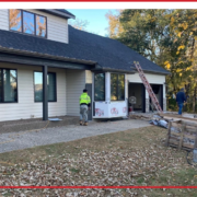Three men replacing the siding on a Minnesota house.
