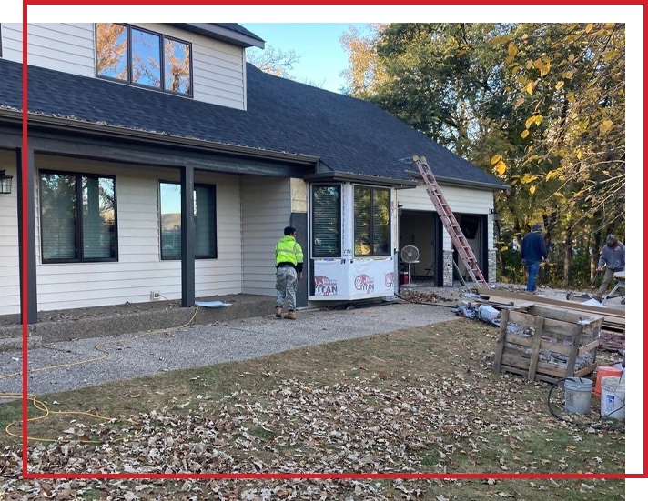 Three men replacing the siding on a Minnesota house.