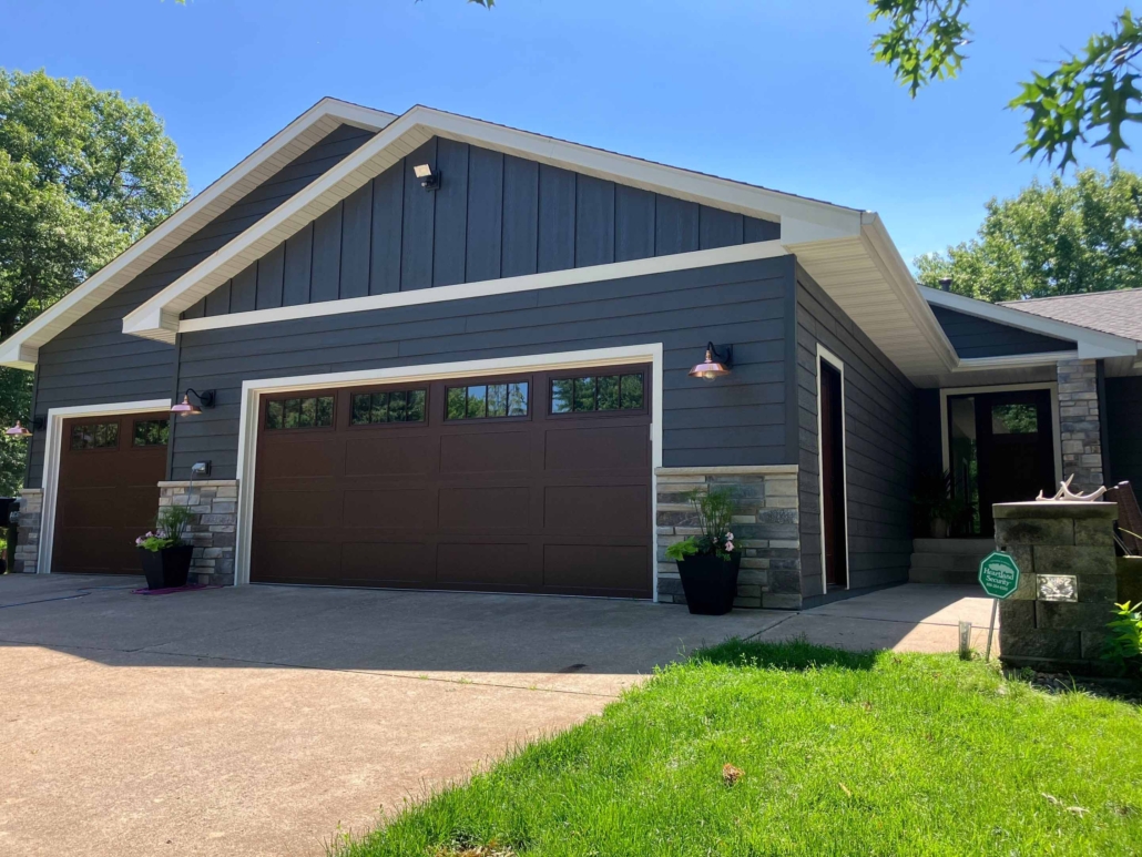After image of a house with new blue siding windows and doors.