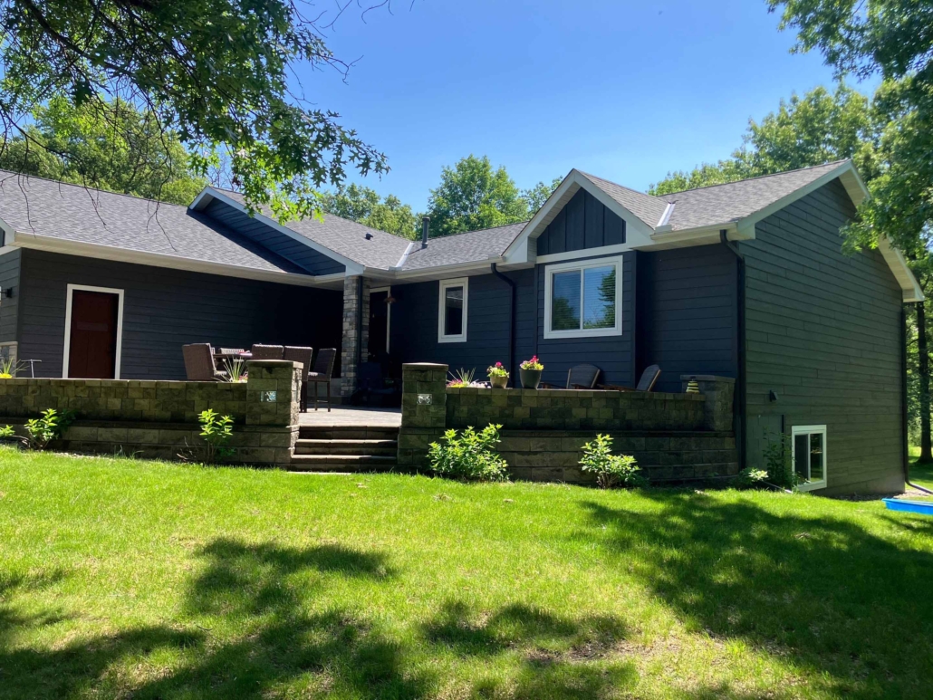 After of image of a house that recently receive new blue siding