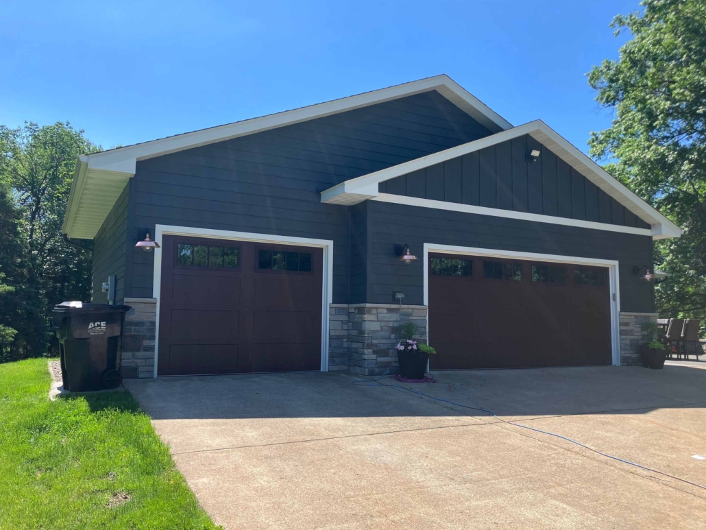 After image of a house with new blue siding windows and doors.