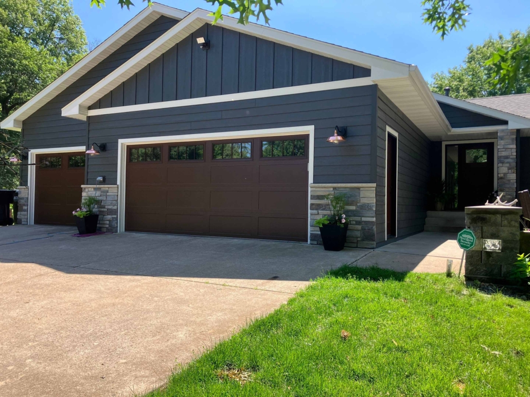 After image of a house with new blue siding windows and doors.
