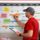 A contractor marking off a project calendar with important dates.