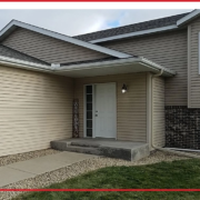 House sidewalk protected from winter ice by proper gutter installation.