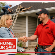 A contractor shaking hands with a homeowner in front of a house for sale.