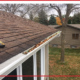 A section of gutters that is full of leaves.