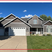 Well-designed Central Minnesota home exterior with coordinated roofing, siding, trim, and gutters.