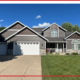 Well-designed Central Minnesota home exterior with coordinated roofing, siding, trim, and gutters.