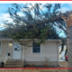A tree that broke off and fell onto a house’s roof.